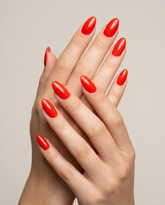 Hands with MineVital Oranje C23 manicure — bright vivid red water-based breathable nail polish on natural nails