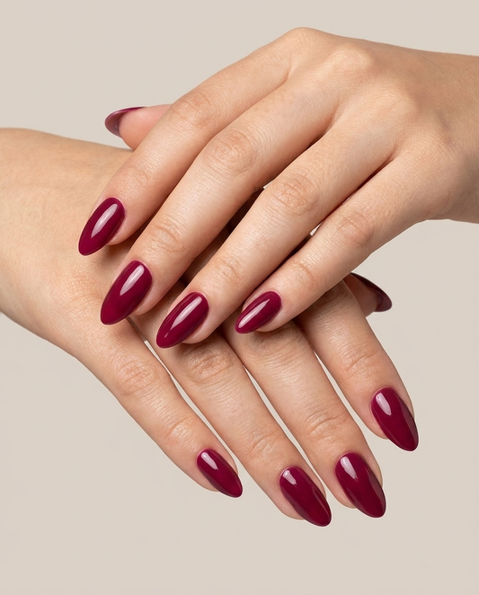 Hands with MineVital Possibility manicure — rich berry-wine red water-based breathable nail polish on natural nails